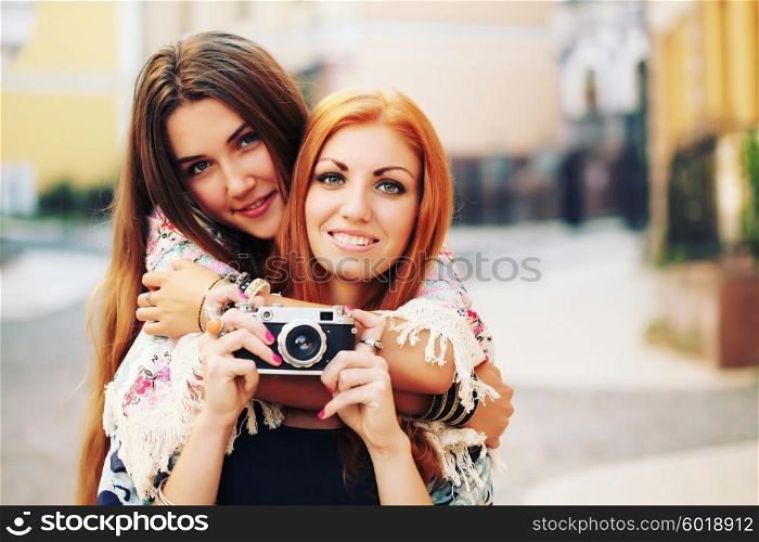 Two female friends hanging out with camera