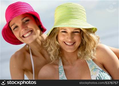 Two female friends having fun at the beach