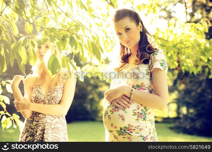 Two female friends in the summer park