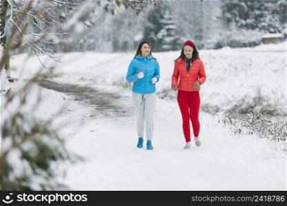 two female friends jogging winter