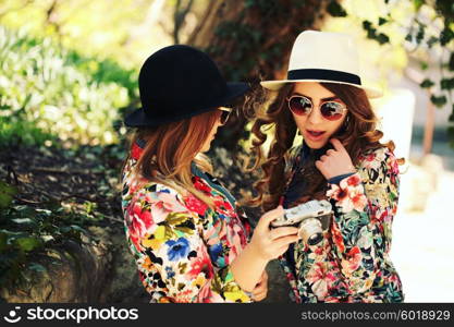 Two female friends taking pictures