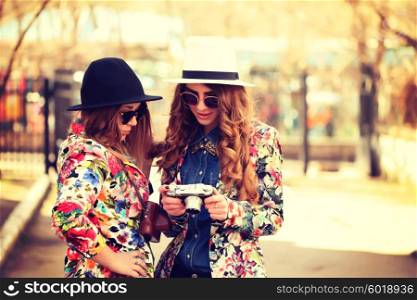 Two female friends taking pictures
