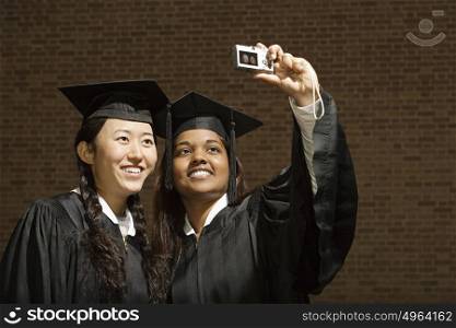 Two female graduates taking a photograph