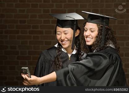 Two female graduates taking a photograph