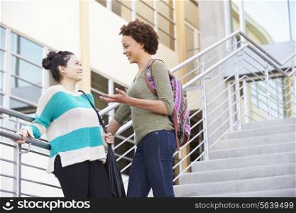 Two Female High School Students Standing Outside Building