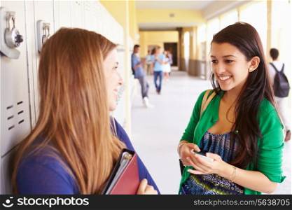 Two Female High School Students Talking By Lockers