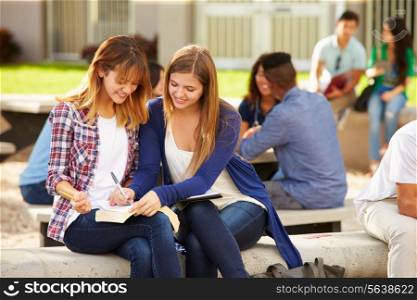 Two Female High School Students Working On Campus