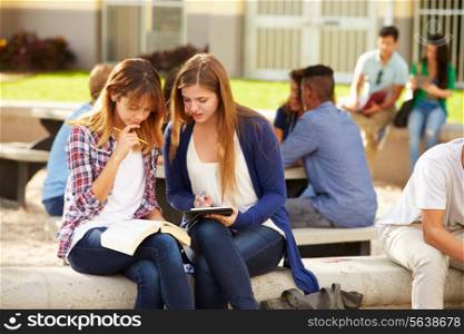 Two Female High School Students Working On Campus