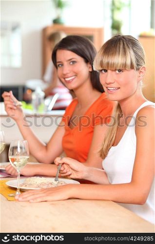 Two female housemates eating at home