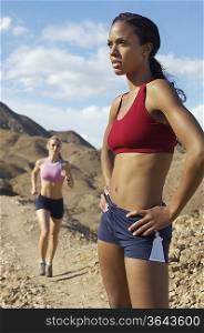 Two female joggers in mountains