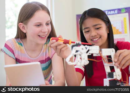 Two Female Pupils In Science Lesson Studying Robotics