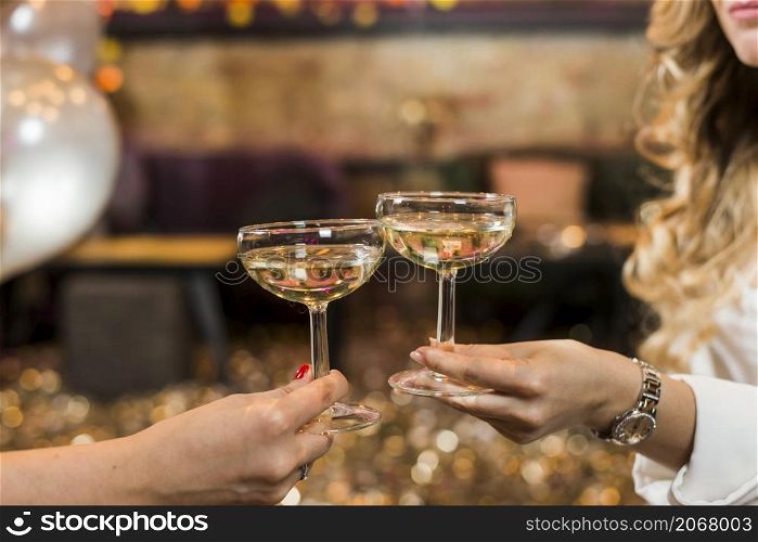 two female s hand toasting whiskey night club