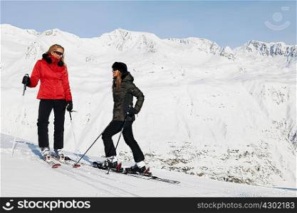 Two female skiers talking, Obergurgl, Austria