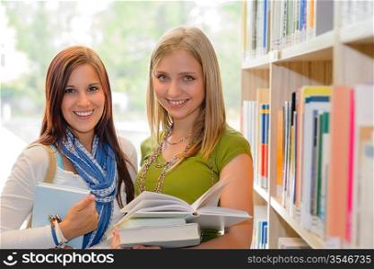Two female students at school library studying books together
