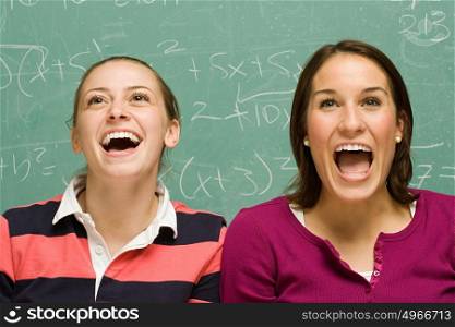 Two female students showing surprise