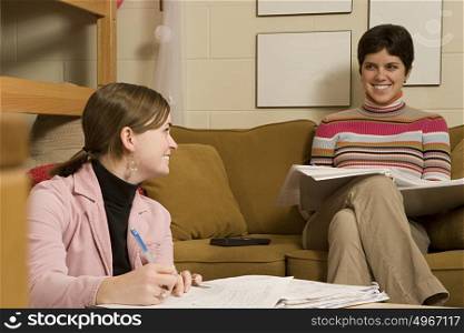 Two female students studying in their dormitory