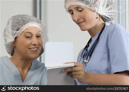 Two female surgeons discussing a medical report
