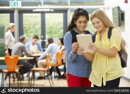 Two Female Teenage Students In Classroom With Digital Tablet