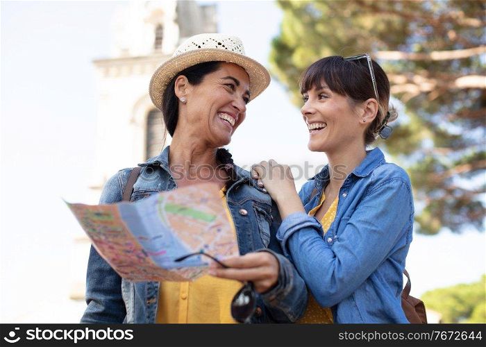 two female tourist looking at the map of parisian metro