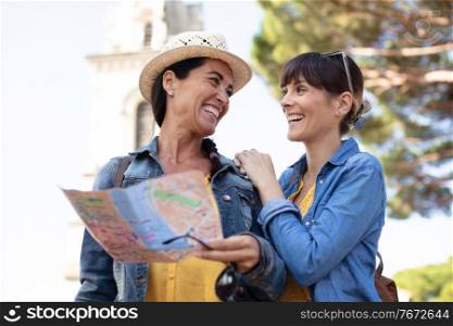 two female tourist looking at the map of parisian metro