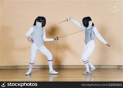 Two fencers fencing