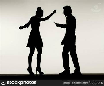 Two fighting silhouettes of the young marriage couple