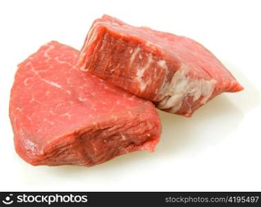 two filet mignon steaks, cut from beef tenderloin, with a light shadow
