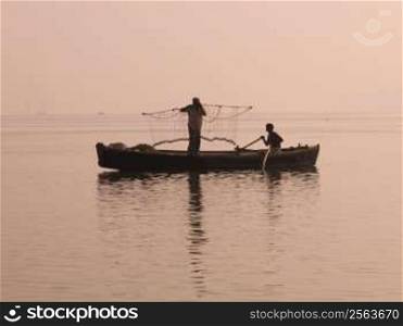 Two fishers on boat, Ganges, Varanasi, India