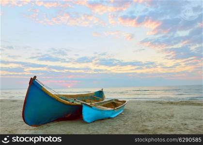 two Fishing boats and sunrise on Black Sea beach