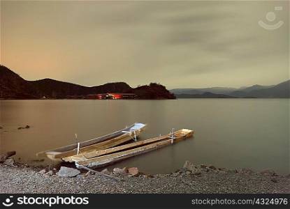 Two fishing boats moored on lakeside, Lugu Lake, Yunnan, China