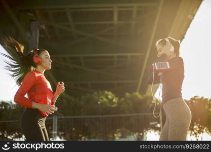 Two fitness women doing  exercise before running outdoor in urban environment