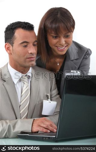 Two flirtatious businesspeople working together