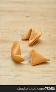 Two fortune cookies isolated on a wooden background