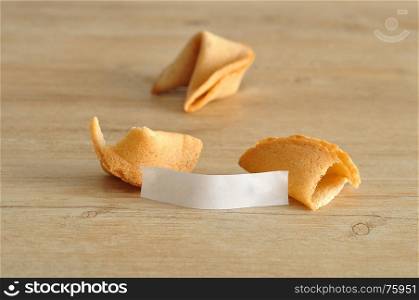 Two fortune cookies isolated on a wooden background