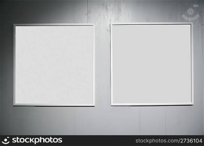 two frames on white wood wall