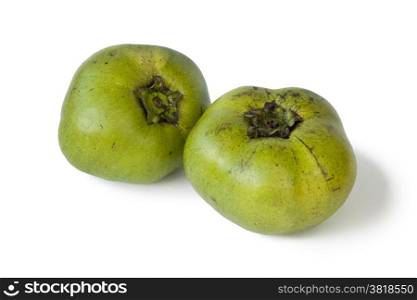 Two fresh black sapote fruit on white background