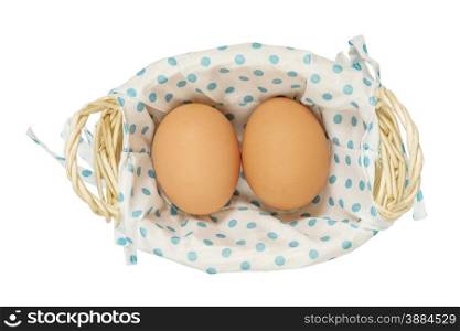 Two fresh brown eggs in a wicker basket on a white background