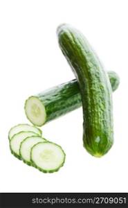 Two fresh English cucumbers, with one sliced. Shot on white background.