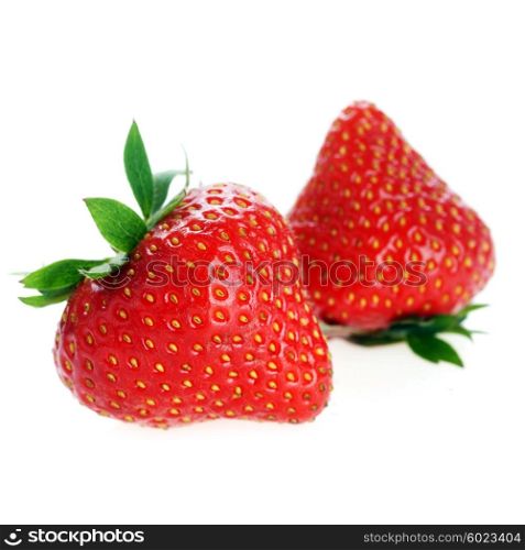 two fresh red strawberries with leaves