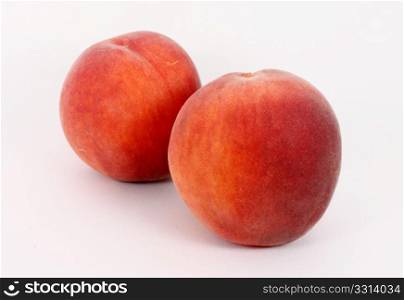 Two fresh ripe peaches, isolated