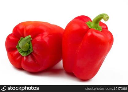 Two fresh sweet peppers and white background.