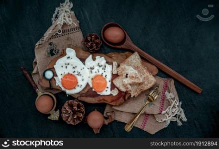 Two fried eggs with toast for healthy breakfast on beautiful wooden background, Nutrition concept, The view from the top.