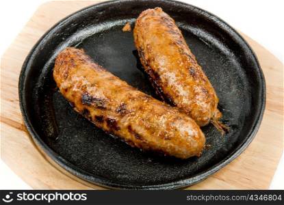 Two fried sausages at the pan close up