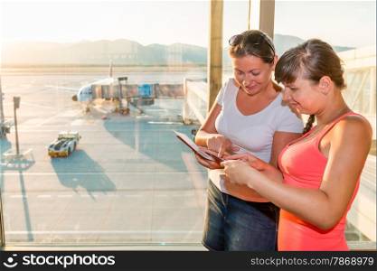 two friends are considering boarding tickets at the airport