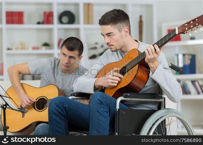 two friends are playing guitar