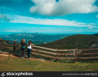 Two friends contemplating the landscape in Picos de Europa, in Asturias, Spain