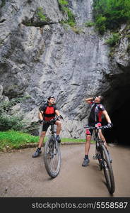 two friends have fun outdoor in nature and representing concept of healthy life and fitnes on muntain bike