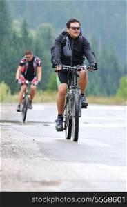 two friends have fun outdoor in nature and representing concept of healthy life and fitnes on muntain bike