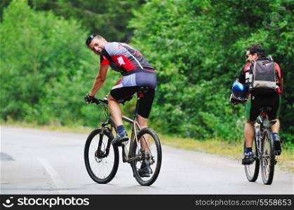 two friends have fun outdoor in nature and representing concept of healthy life and fitnes on muntain bike