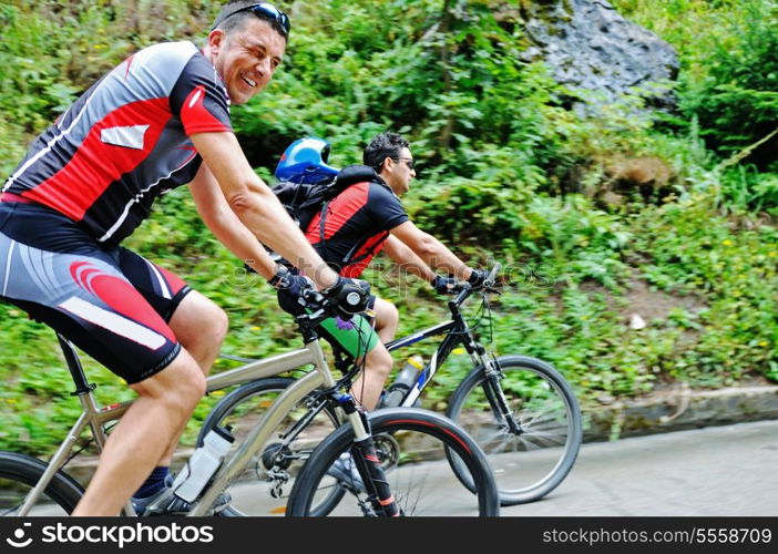 two friends have fun outdoor in nature and representing concept of healthy life and fitnes on muntain bike